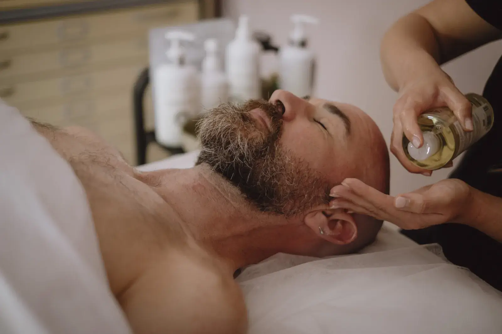 Facial treatment oil applied during a facial