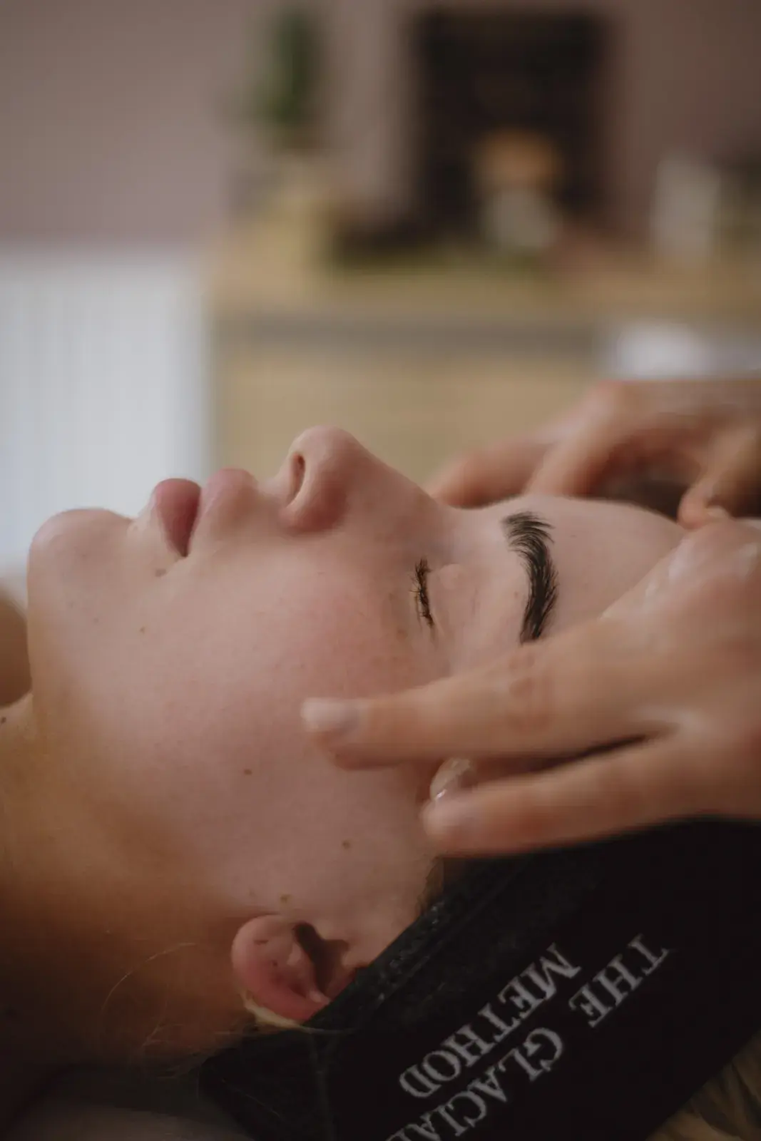 A facial massage, the client in a Glacial Method headband